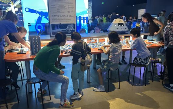 families building with Lego bricks at the 'Artemis Adventure with Lego Bricks'