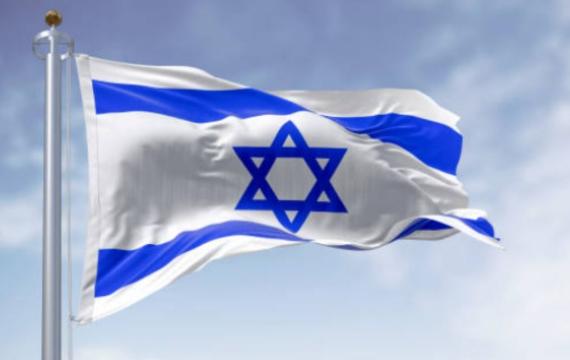 the national flag of Israel waving in the wind