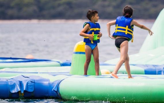 Children playing on inflatable floating water park