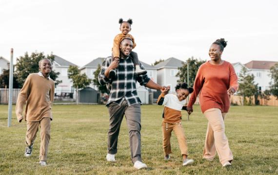 A happy African American family hold hands as they celebrate Juneteenth.