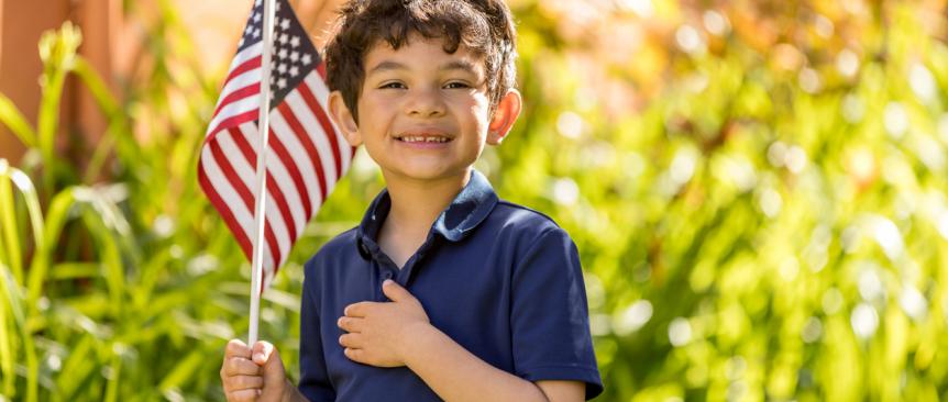 little boy holding an american flag