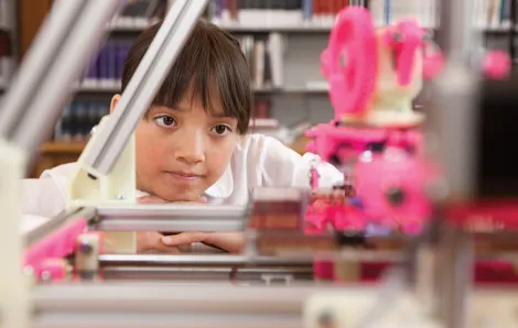 Girl watching 3D printer