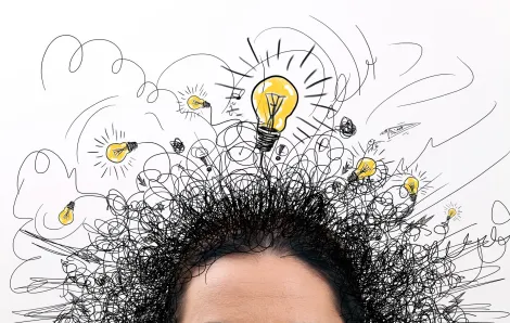 Black hair with doodles and lightbulb over it