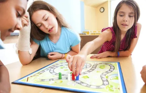 Young girls play a board game