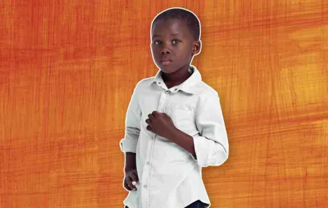 Little black boy against orange background