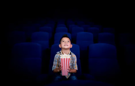 Boy watching movie with popcorn