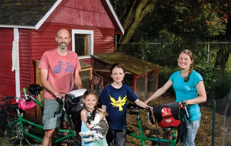 Family with chicken and bike