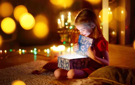 Little girl opening magic gift box