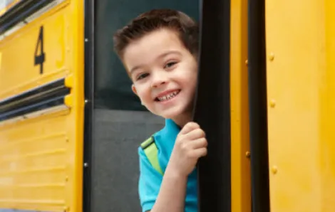 Boy smiling on school bus
