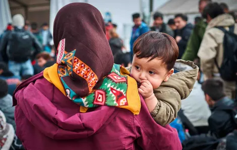 Refugee mother holds son