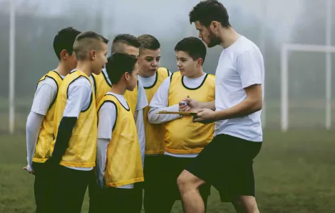 Soccer team talks to coach