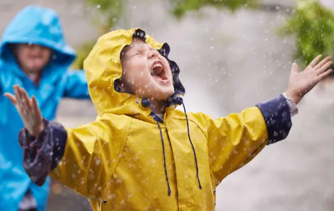 Boy shouting into the rain