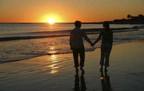 Couple hand-in-hand on the beach