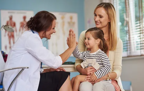 Doctor giving high five to child