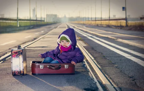 baby-in-suitcase-by-railroad