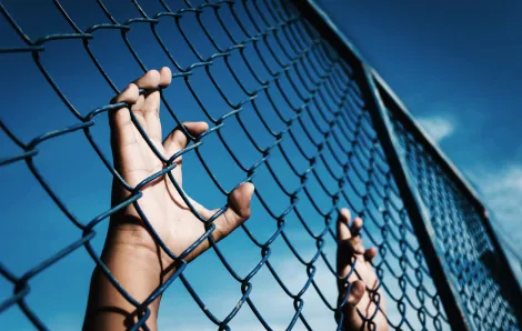 child-clutching-fence
