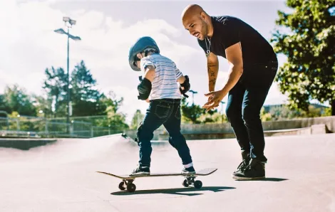 Boy learning to skateboard at skate park