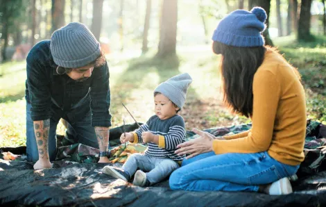 Family setting up camp with a baby