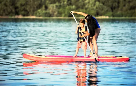 Boy and mom stand-up paddleboarding