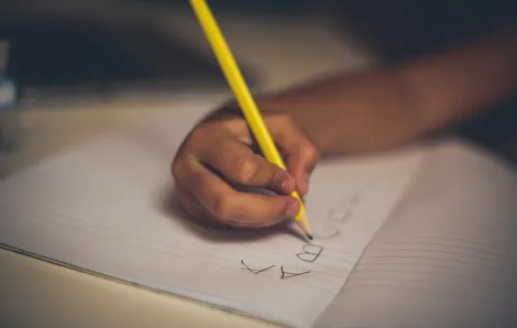 Child handwriting with pencil