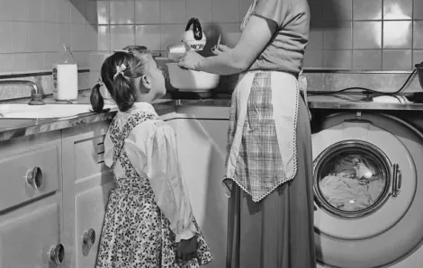Vintage photo of a mother and child in a kitchen