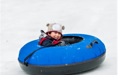 Boy-tubing-in-the-snow-best-places-for-sledding-and-tubing-around-Seattle