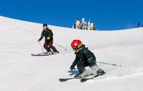 Child and parent skiing at SilverStar Mountain Resort, B.C., Canada one of the best ski resorts