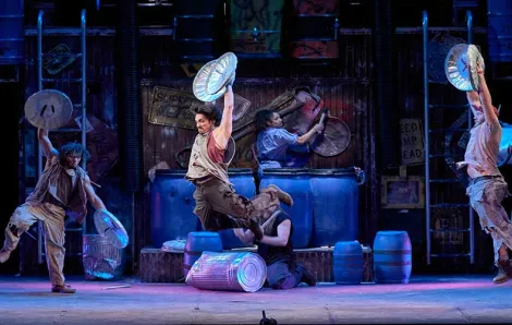 performer soars through the air in "STOMP"