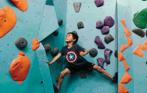 little boy rock climbing