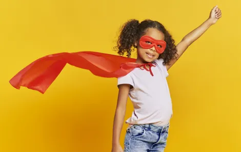 super girl wearing a cape on a yellow background