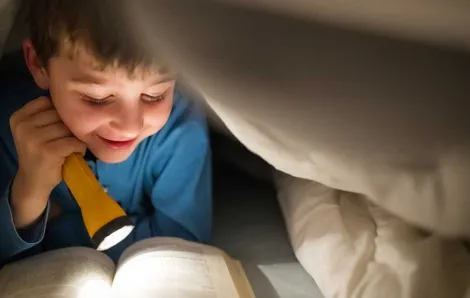 kid reading in bed