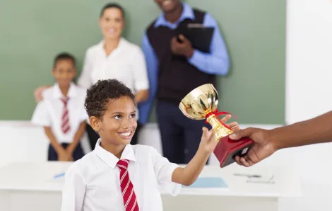 boy being handed a trophy