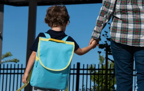 little boy with backpack going back to preschool