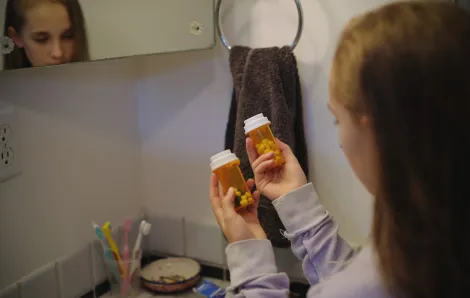 little girl finding prescription pills at home