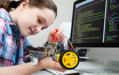 Young girl programs a robot