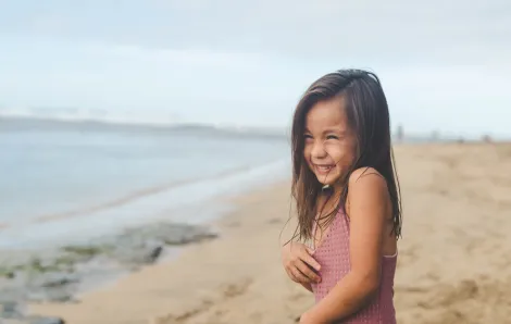girl giggling on the beach