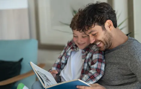father and son reading a picture book together