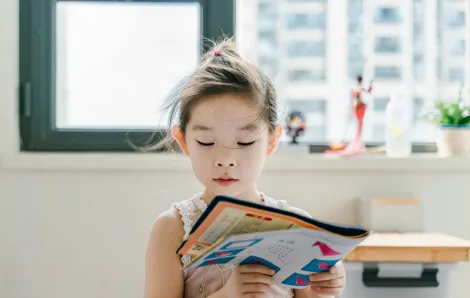 girl reading a picture book