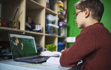 Young student attends school by video conference
