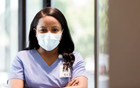 black nurse wearing a mask
