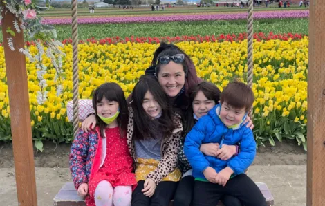 Vivian Song Maritz and her kids with tulip fields in the background
