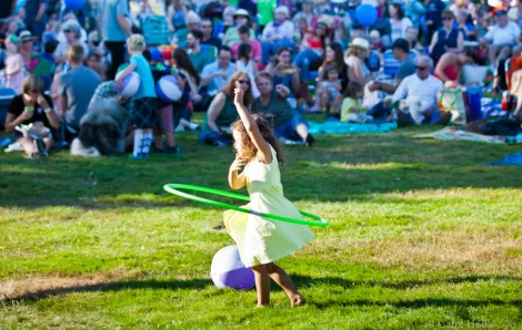 Girl hula hooping at a Seattle summer concert, Celebrate Woodinville an outdoor free concert for families