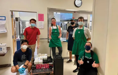 masked teens prepare a mean for homeless youths at Teen Feed