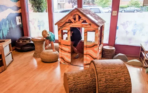 Kids playing in a playhouse inside new Seattle-area indoor play space Child Wonder the World inspiring global learning