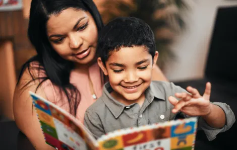 mother and son reading a board book together
