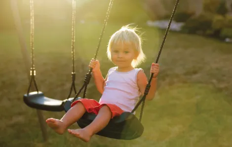 Young child swinging 
