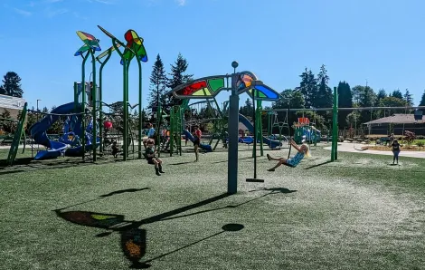 Child on zipline feature at new playground at Emma Yule Park in Everett fun places to play near Seattle