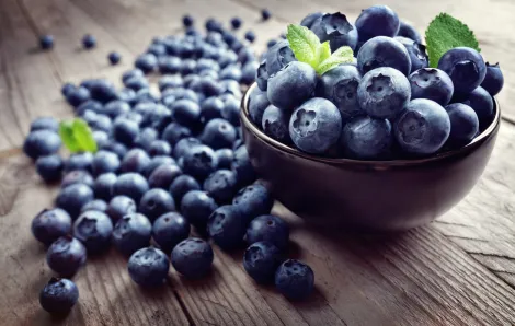 Blueberries on a bowl and on a table