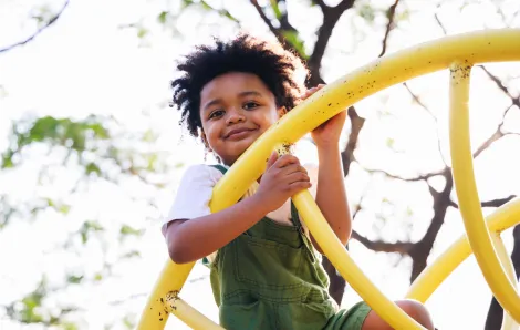 Little boy on a yellow climbing structure 