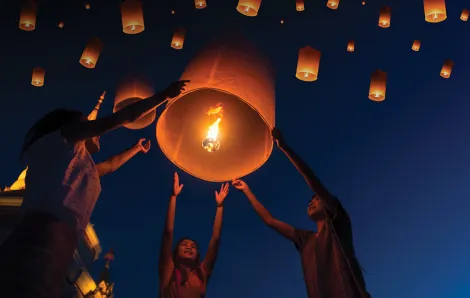 Lantern with fire inside floating up to the sky